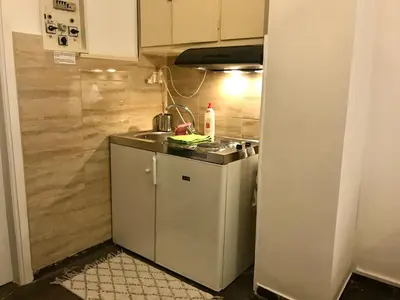 a small kitchen with a sink and a stove at Edem Riviera Studio,close to beach,in Paleo Faliro in Athens