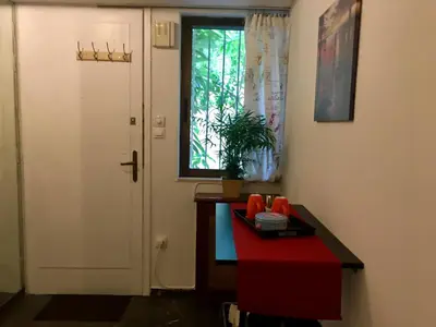 a room with a door and a table and a window at Edem Riviera Studio,close to beach,in Paleo Faliro in Athens