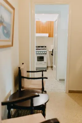 a kitchen with a stove and chairs in a room at BEST HOUSE, Attiki Metro, Athens in Athens