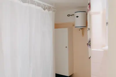 a bathroom with a white shower curtain and a window at BEST HOUSE, Attiki Metro, Athens in Athens