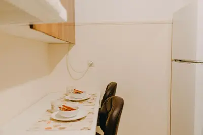 a table with two chairs and plates of food on it at BEST HOUSE, Attiki Metro, Athens in Athens