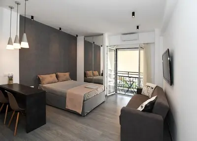 a bedroom with a bed and a table and a couch at Nest Apartment in Athens