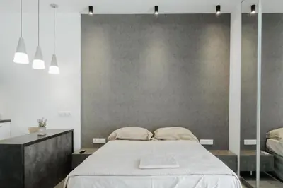 a bedroom with a bed and a wall at Nest Apartment in Athens