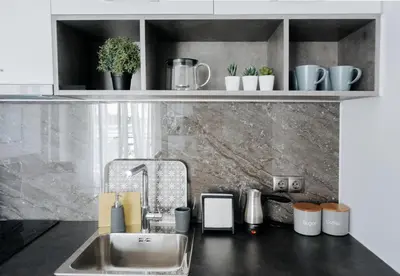a kitchen with a sink and a shelf with plants at Nest Apartment in Athens
