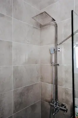a shower with a shower head in a bathroom at Nest Apartment in Athens
