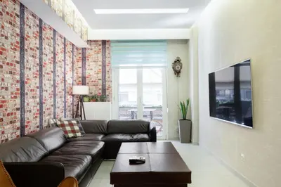 a living room with a couch and a table at Near Acropolis brand new 1 min from metro in Athens