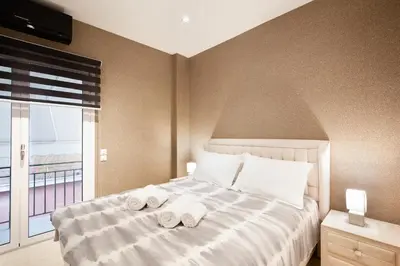 a bedroom with a bed with towels on it at Near Acropolis brand new 1 min from metro in Athens