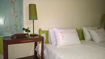 a bedroom with a bed and a table with a lamp at Spitaki Spata Airport Studio in Spáta