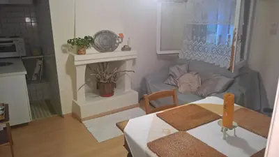 a small living room with a table and a couch at Spitaki Spata Airport Studio in Spáta
