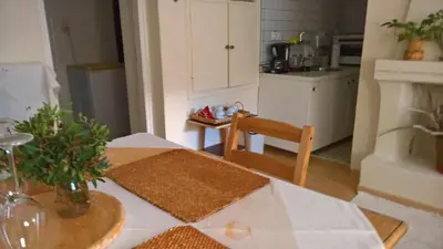 a kitchen with a table with a white counter top at Spitaki Spata Airport Studio in Spáta