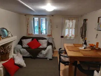 a living room with a table and a couch at Spitaki Spata Airport Studio in Spáta