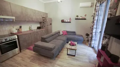 a living room with a couch and a table at D16-Cosy downtown apartment in Athens