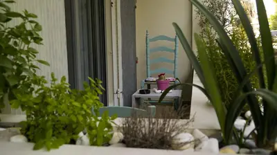 a patio with plants and a table and a chair at D16-Cosy downtown apartment in Athens