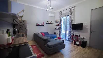 a living room with a couch and a tv at D16-Cosy downtown apartment in Athens