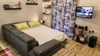 a bedroom with a bed and a flat screen tv at D16-Cosy downtown apartment in Athens