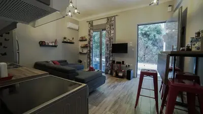 a kitchen and living room with a couch and a table at D16-Cosy downtown apartment in Athens