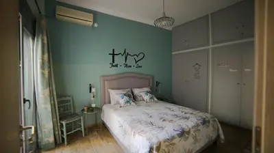 a bedroom with a bed and a blue wall at D16-Cosy downtown apartment in Athens