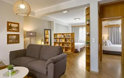 a living room with a couch and a bedroom at Acropolis View Penthouse in Athens
