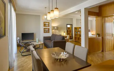 a living room with a dining table and a living room at Acropolis View Penthouse in Athens