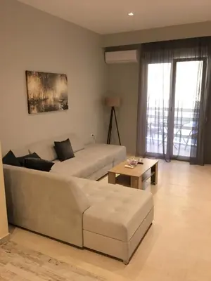 a living room with a couch and a coffee table at Acropolis brand new 1min from metro! in Athens