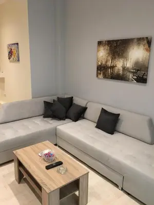 a living room with a couch and a coffee table at Acropolis brand new 1min from metro! in Athens
