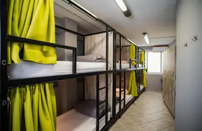 a room with four bunk beds with yellow curtains at Bedway Athens Hostel in Athens
