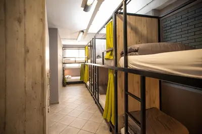 a hallway with four bunk beds in a room at Bedway Athens Hostel in Athens