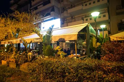a food stand at night with people sitting inside at Bedway Athens Hostel in Athens