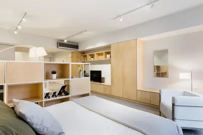 a living room with a bed and a couch at Ermou str. Elegant Apartments by UPSTREET in Athens