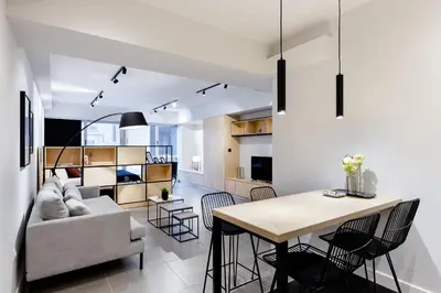a living room and dining room with a couch and a table at Ermou str. Elegant Apartments by UPSTREET in Athens