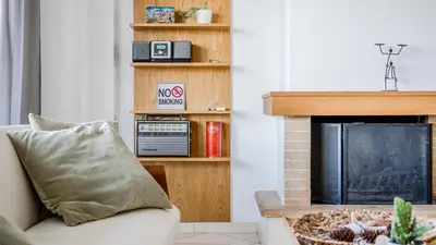 a living room with a couch and a fireplace at Piraeus Bright Apt in Piraeus