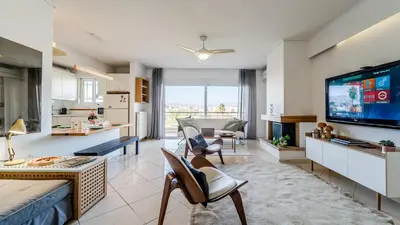 a living room with a large screen tv and a living room at Piraeus Bright Apt in Piraeus
