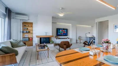 a living room with a couch and a table at Piraeus Bright Apt in Piraeus