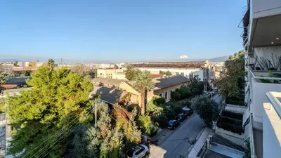a view of a city street with trees and buildings at Piraeus Bright Apt in Piraeus