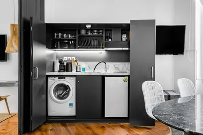 a kitchen with a washing machine and a sink at Art Pantheon - Suites & Apartments in Athens
