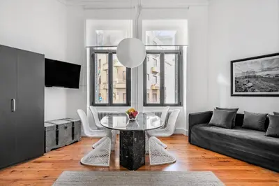 a living room with a table and a couch at Art Pantheon - Suites & Apartments in Athens