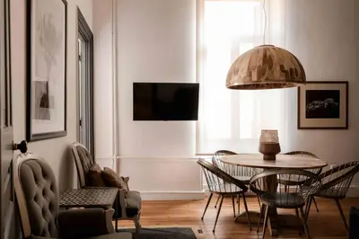 a living room with a table and chairs at Art Pantheon - Suites & Apartments in Athens