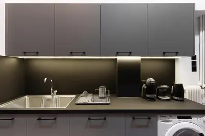 a kitchen with a sink and a washing machine at Art Pantheon - Suites & Apartments in Athens