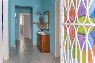 a hallway with blue walls and a mirror at Casa Bonita, House with Private Entrance and Garden, between center and sea in Athens