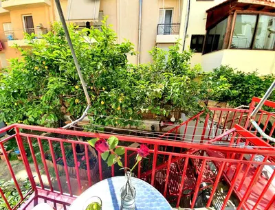 a table with a flower on top of a balcony at Casa Bonita, House with Private Entrance and Garden, between center and sea in Athens