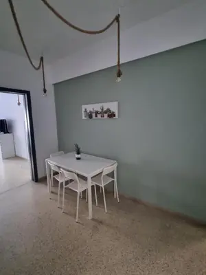 a white table and chairs in a white room at athens.apartotel.2 in Athens