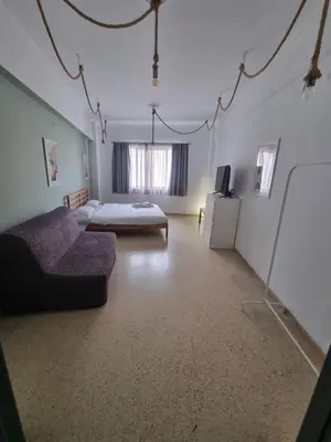 a living room with a couch and a bed at athens.apartotel.2 in Athens