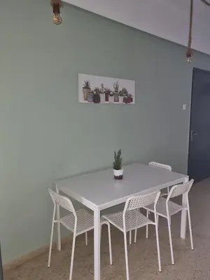 a white table and chairs in a room at athens.apartotel.2 in Athens