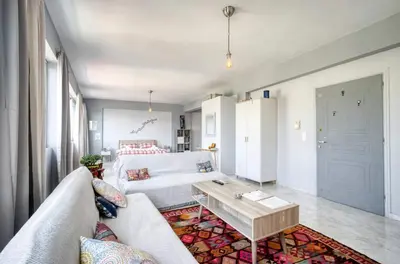 a living room with a couch and a table at A little Taste of Home Apartments in Athens