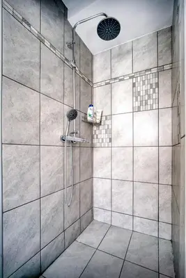 a bathroom with a shower with a glass door at A little Taste of Home Apartments in Athens