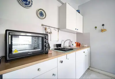a microwave sitting on a counter in a kitchen at A little Taste of Home Apartments in Athens