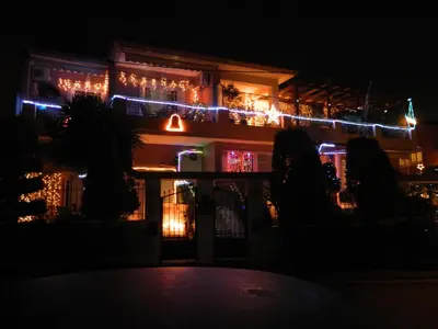 a building with christmas lights on it at night at Stella's Home in Glyka Nera