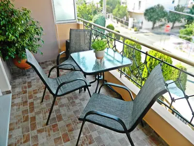 a balcony with a table and chairs on a balcony at Stella's Home in Glyka Nera
