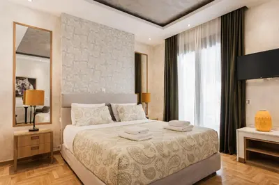 a bedroom with a bed with two towels on it at Nicholas Point Apartments and Rooms in Athens