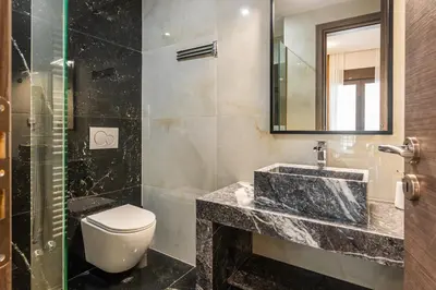 a bathroom with a sink and a toilet and a mirror at Nicholas Point Apartments and Rooms in Athens